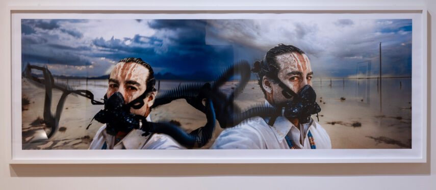The image features two men side by side, each wearing black breathing masks.